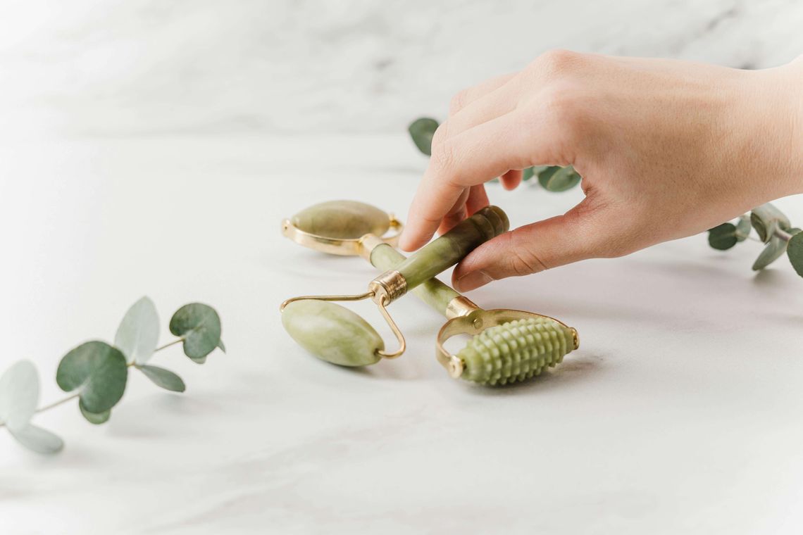 wellness tools next to fresh green leaves